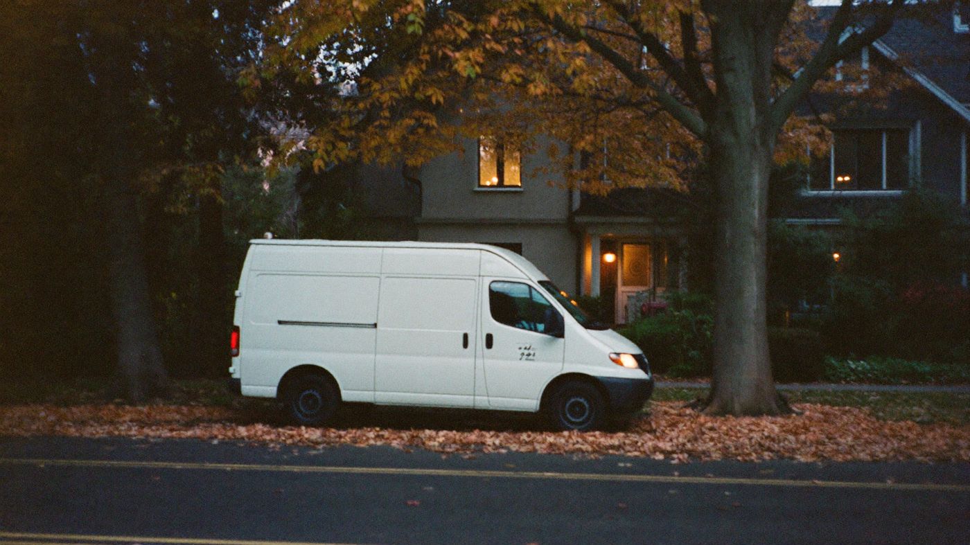 Delivery van on a quiet residential street at dusk